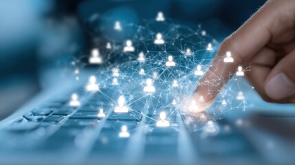 Finger touching laptop, a glowing network of connected human icons overlaying keyboard