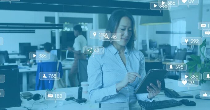 Social media manager scrolling tablet activating floating metrics icons for tracking engagement