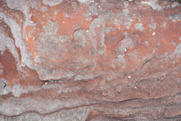 Natural red stone wall with wavy Cross-Bedding texture and white stains