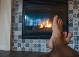 Cozy Feet Warming by a Glowing Fireplace with Patterned Tiles