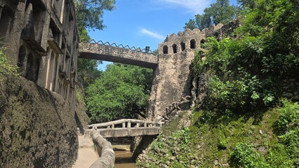 Stone bridges connect pathways across scenic garden streams