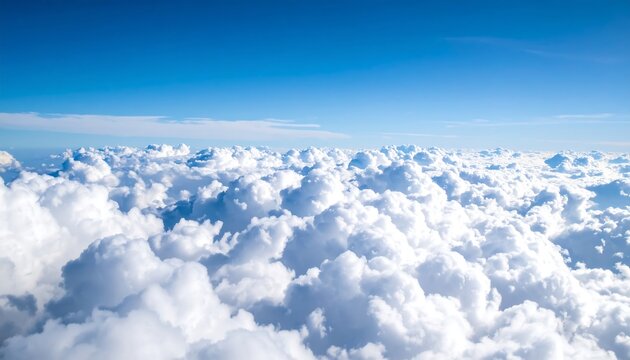 High-altitude view of fluffy white clouds against a vibrant blue sky