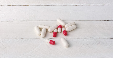capsules with various medicines on a white background