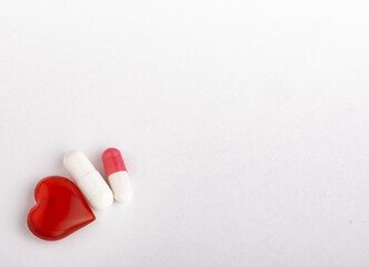 capsules with medicine and a heart the concept of medicine with copy space