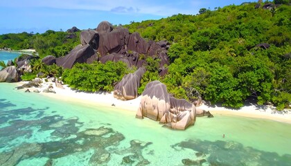 Tropical island beach with granite boulders