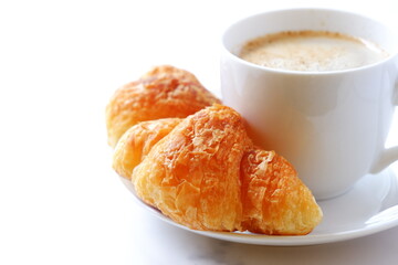 Cup of coffee and croissants
