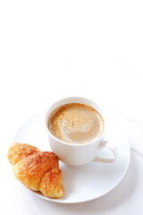Cup of coffee and croissants
