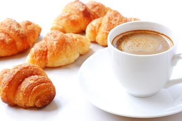 Cup of coffee and croissants
