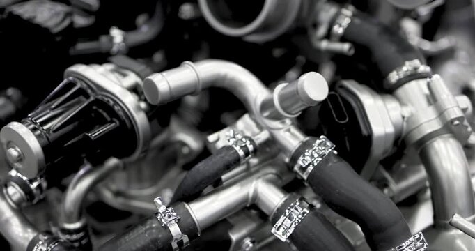 Close up view of Modern automotive engine pipe lines in monochrome