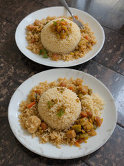 Nasi pecel and sego pecel are typical Javanese Indonesian rice dishes served with pecel sauce, vegetables and others.