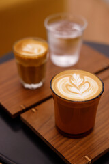 Cup of hot milk latte coffee on table.