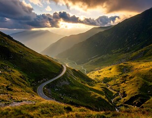 Winding mountain road at sunset.  Golden light bathes a scenic valley carved by a winding road, with lush green slopes and distant peaks