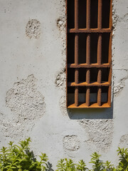 Background, texture. Iron rusted fittings in a breakaway concrete wall and plaster. The iron lattice