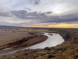 Missouri river on overcast day at sunset looking at a bend in the river 