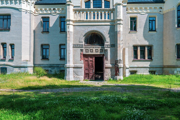 Facade of a vintage building with wooden antique doors.