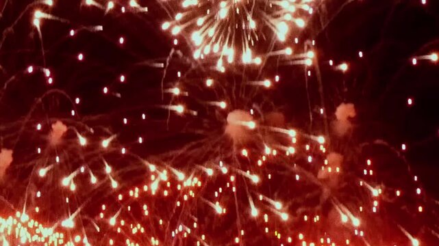 Watch the luminous spectacle as golden fireworks explode overhead, filling the evening with dazzling light and vibrant energy during the Summer Festival at night.