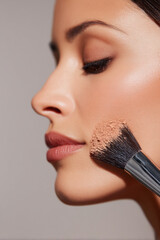 zoomed-in makeup process applying powder on jawline