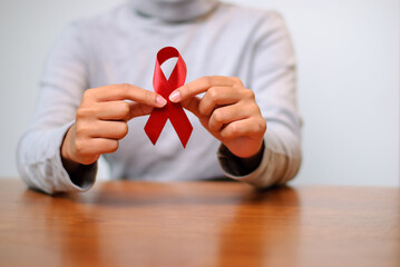 Awareness event red ribbon community center indoor space close-up health advocacy