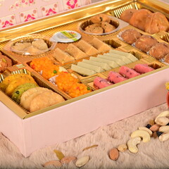 Delicious sweet treats including cakes, candies, and desserts beautifully styled with soft lighting...