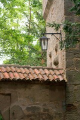 Historic lantern mounted on medieval stone wall, architectural detail