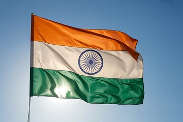 Majestic Indian flag waves proudly against a clear blue sky, symbolizing national pride and freedom