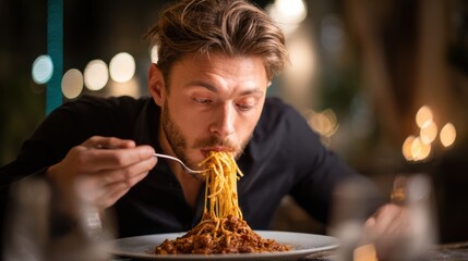 Mid adult man enjoying a delicious plate of spaghetti bolognese at a restaurant. 
