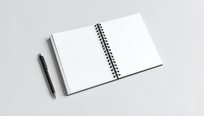 Open spiral notebook and pen on a light gray surface