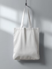 Minimalist White Tote Bag Hanging on Wall in Soft Lighting