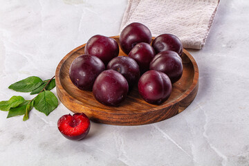Raw ripe purple plum heap