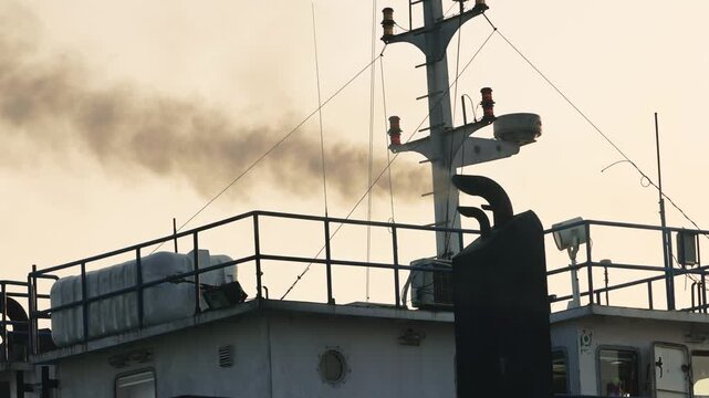 Black smoke from ferry boat flue, close up. Chimney of a ferry or ship, smokestack pollutes the atmosphere. Air pollution concept. Smoke from the exhaust pipe on the ship. slow motion video.
