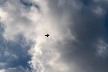 flying airplane with clouds in the sky