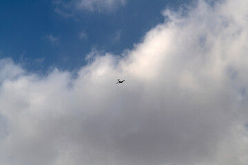flying airplane with clouds in the sky