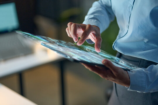 Professional Touches Futuristic Tablet Screen, Showcasing Advanced Technology, Innovative Interface, and Digital Interactions in Office Space, Representing Modern Business Solutions.