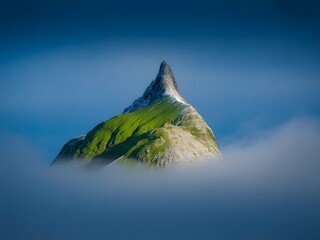Jagged peak emerges from clouds mountain summit