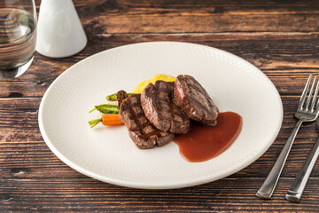 Juicy grilled filet medallions served with seasonal vegetables and sauce