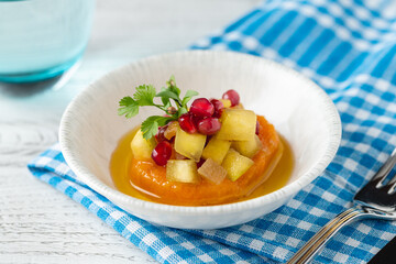 Sweet potato puree topped with fruit cubes and pomegranate