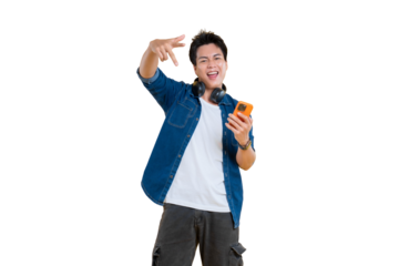 A young man joyfully holding a phone while gesturing a hand sign, with headphones around his neck, portraying confidence and charisma on png background