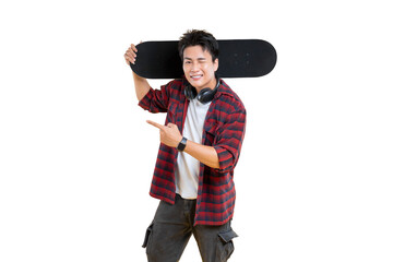 Stylish young man confidently poses with a skateboard on his shoulder and pointing. The subject is wearing a checkered shirt, cargo pants and shows headphones on png background
