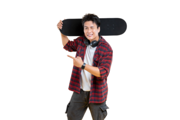 Stylish young man confidently poses with a skateboard on his shoulder and pointing. The subject is wearing a checkered shirt, cargo pants and shows headphones on png background