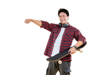 A young man holding a skateboard, smiling and pointing towards something on png background