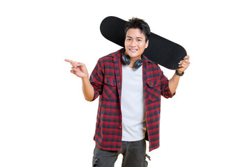 A young man with a skateboard is pointing with a smile on his face on png background
