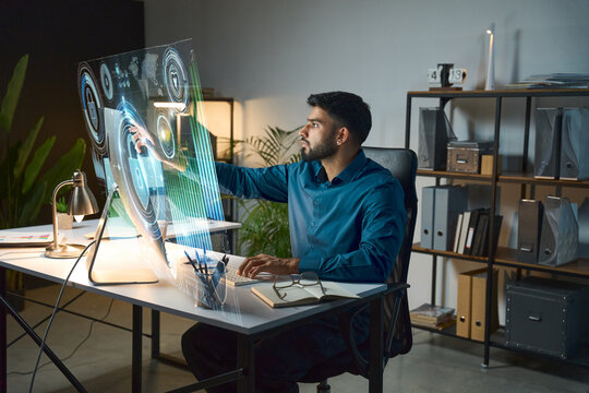 Modern Office Environment Featuring Man Interacting With Futuristic Holographic Interface, Symbolizing Innovation And Advanced Technology. 