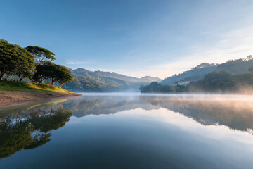 experience tranquility of lakes at dawn where calm waters reflect soft hues of sunrise © Natia