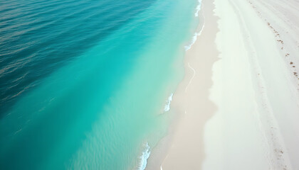 Aerial view of stunning turquoise ocean water meeting pristine white sand beach coastline