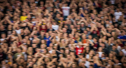 Obraz premium A large crowd of people enthusiastically cheering.