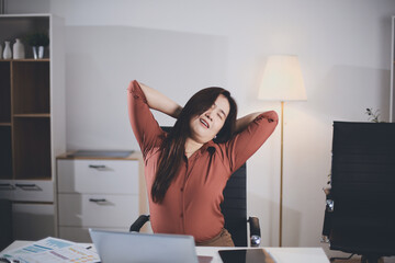 Attractive Asian business woman Relax from work after sitting for a long time. in order not to...