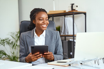 Confident Businesswoman Working On Digital Tablet While Smiling In A Modern Office Setting,...