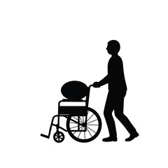 Fototapeta premium Man Pushing Empty Wheelchair Silhouette