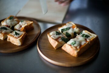 切り分けたピザトーストを木の器に並べたところ