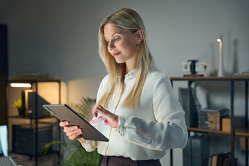 Professional Woman Using Digital Tablet In Modern Office Setting, Illustrating Technology,...